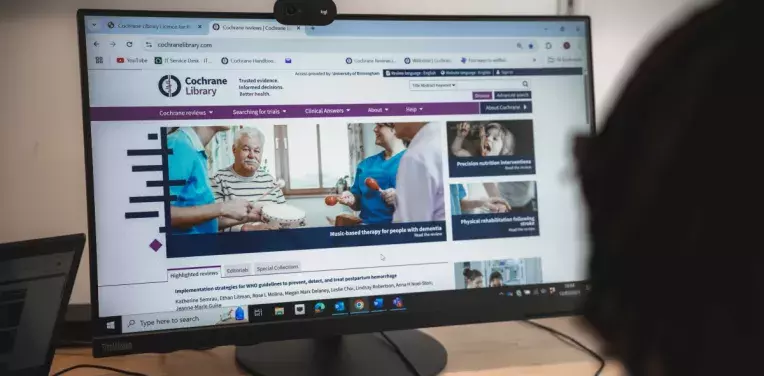 Someone looking at the Cochrane Library website on a desktop computer